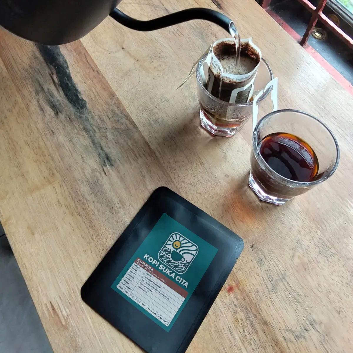 Pouring hot water over a Kopi Suka Cita single-brew drip bag