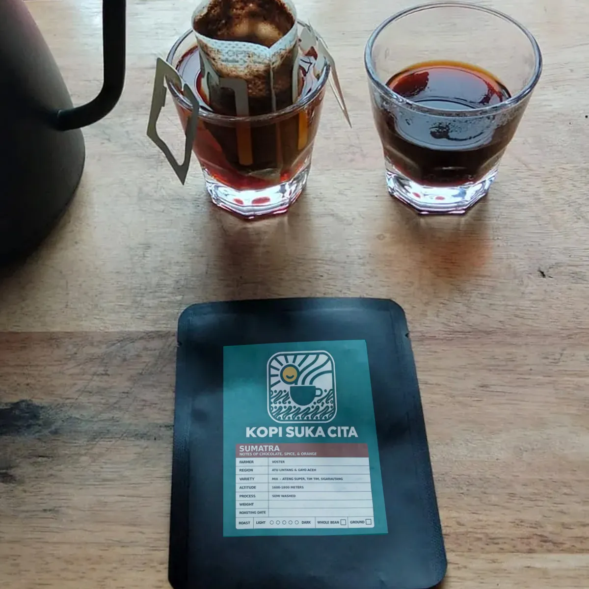A Kopi Suka Cita single-brew drip bag steeping in a glass
